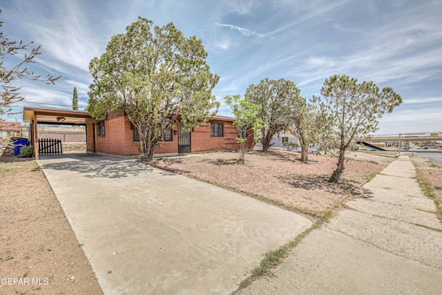 4209 Hercules Ave, El Paso, TX 79904 - ranch-style house with driveway, brick siding, fence, and a carport