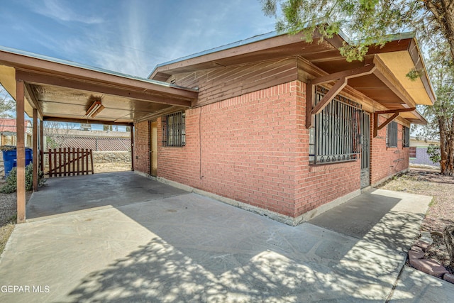 4209 Hercules Ave, El Paso, TX 79904 - view of home's exterior featuring brick siding and a carport