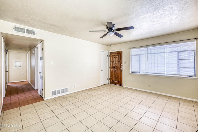4209 Hercules Ave, El Paso, TX 79904 - spare room with a ceiling fan, light tile patterned floors, a textured ceiling, and baseboards