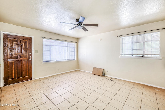 4209 Hercules Ave, El Paso, TX 79904 - spare room featuring ceiling fan, plenty of natural light, baseboards, and a textured ceiling