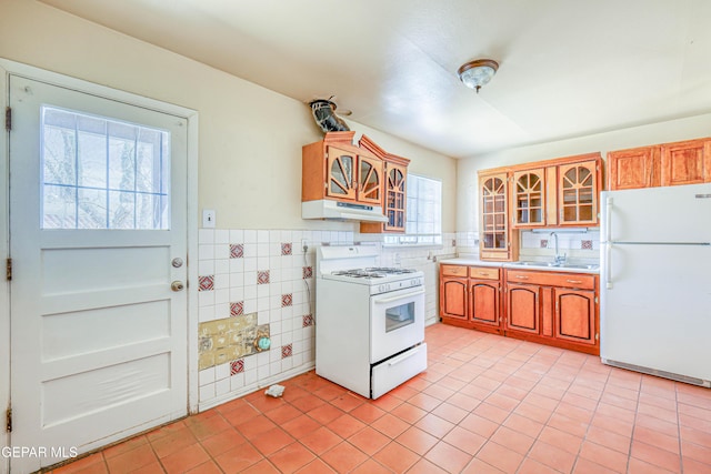 4209 Hercules Ave, El Paso, TX 79904 - kitchen featuring white appliances, under cabinet range hood, a sink, light tile patterned flooring, and light countertops
