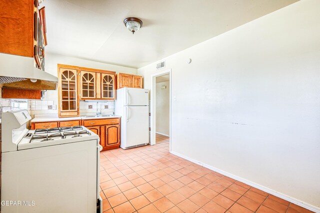 4209 Hercules Ave, El Paso, TX 79904 - kitchen featuring white appliances, a sink, baseboards, light tile patterned floors, and light countertops