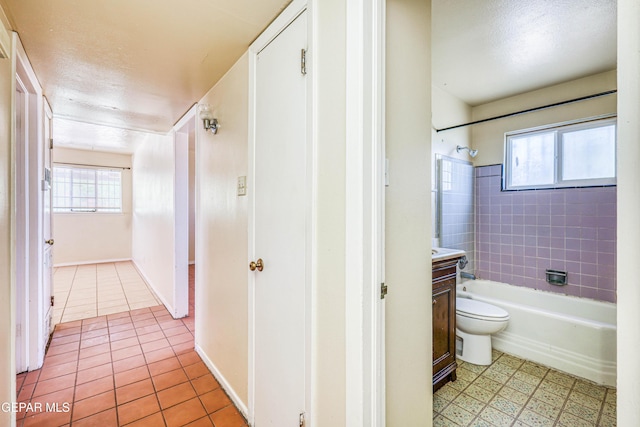 4209 Hercules Ave, El Paso, TX 79904 - bathroom with toilet, plenty of natural light, shower / bath combination, tile patterned floors, and a textured ceiling