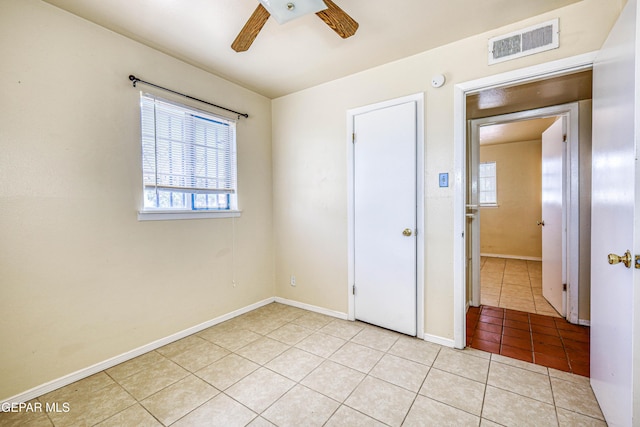 4209 Hercules Ave, El Paso, TX 79904 - unfurnished bedroom with light tile patterned floors, baseboards, and ceiling fan