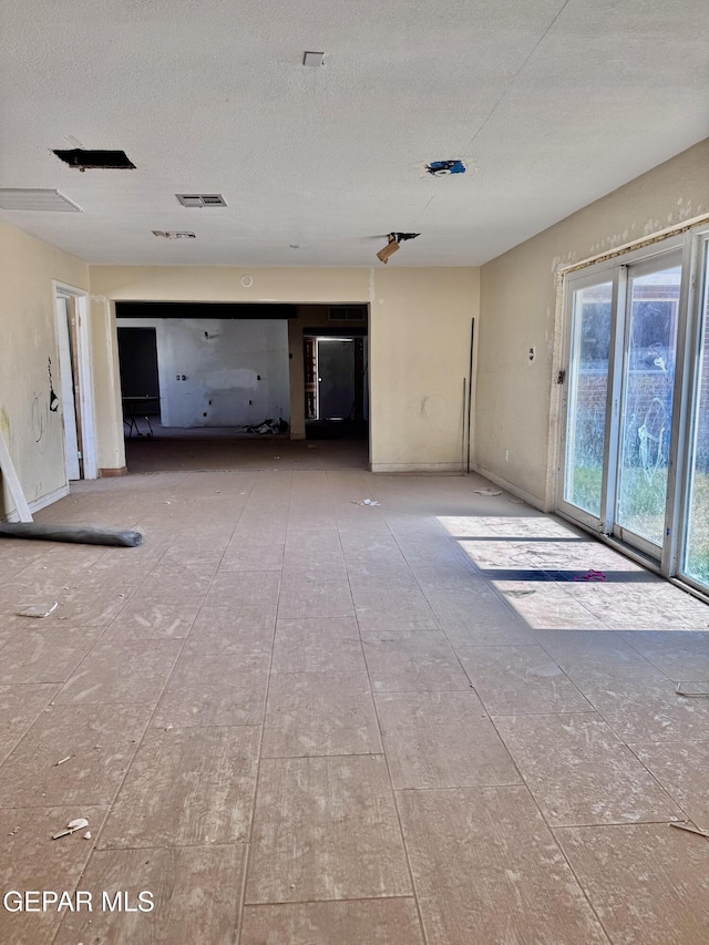 4500 Frankfort Ave, El Paso, TX 79903 - unfurnished living room featuring a textured ceiling