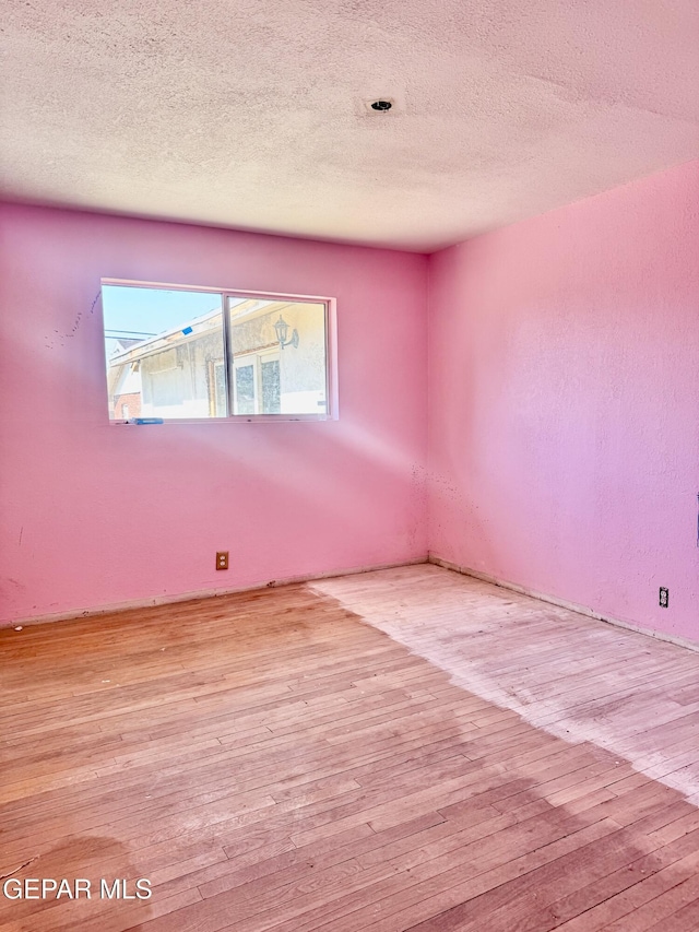 4500 Frankfort Ave, El Paso, TX 79903 - unfurnished room featuring hardwood / wood-style floors and a textured ceiling