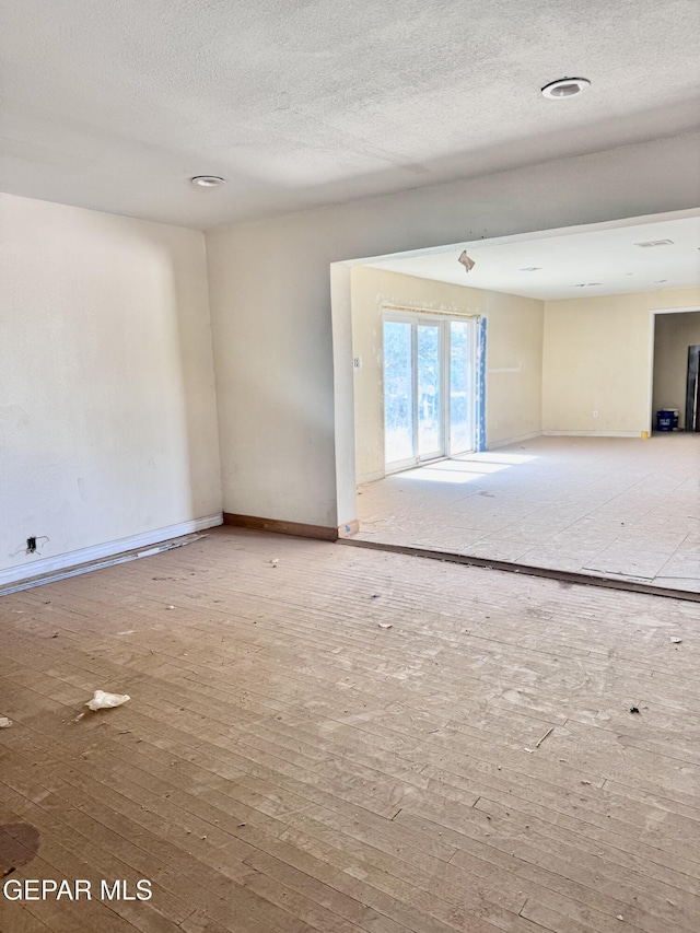 4500 Frankfort Ave, El Paso, TX 79903 - empty room with hardwood / wood-style floors, a textured ceiling, and baseboards