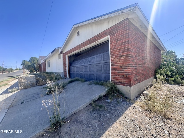 4500 Frankfort Ave, El Paso, TX 79903 - view of side of home featuring brick siding, driveway, and a garage
