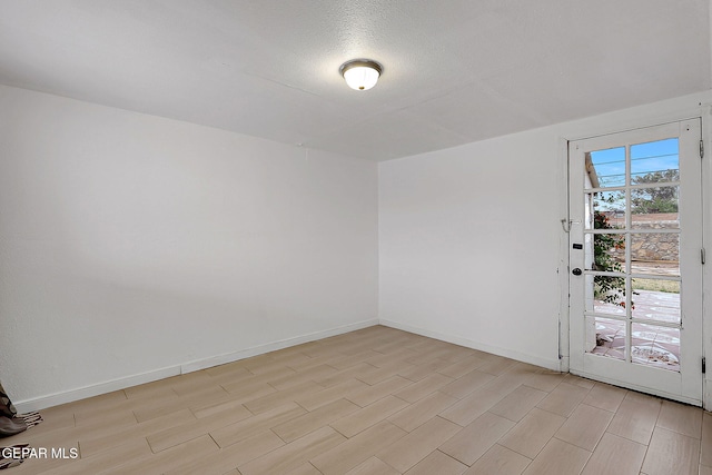 5713 Sanders Ave, El Paso, TX 79924 - spare room featuring baseboards, light wood-type flooring, and a textured ceiling