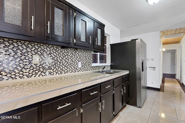 5713 Sanders Ave, El Paso, TX 79924 - kitchen featuring light countertops, a sink, tasteful backsplash, stainless steel fridge, and light tile patterned flooring