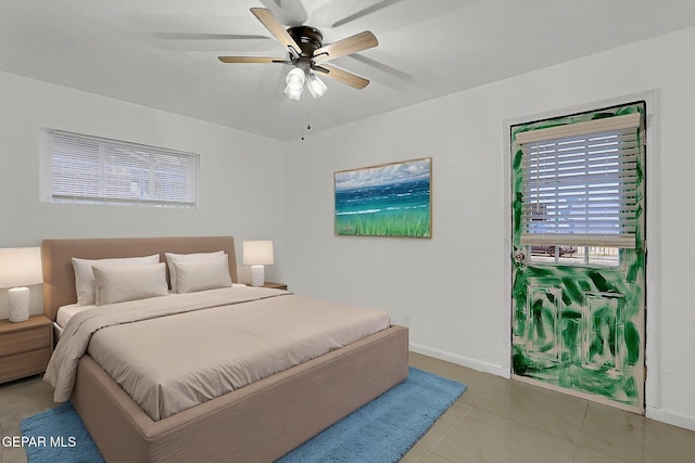 5713 Sanders Ave, El Paso, TX 79924 - bedroom featuring baseboards, light tile patterned flooring, and a ceiling fan
