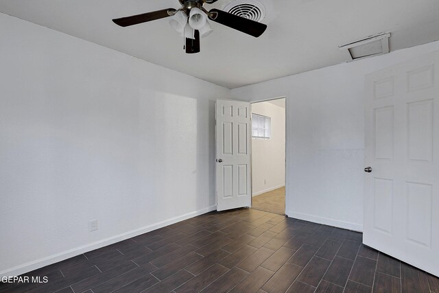 5713 Sanders Ave, El Paso, TX 79924 - spare room featuring baseboards, dark wood-style flooring, a ceiling fan, and attic access