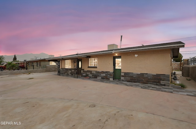 5713 Sanders Ave, El Paso, TX 79924 - back of property at dusk featuring a patio area and a chimney