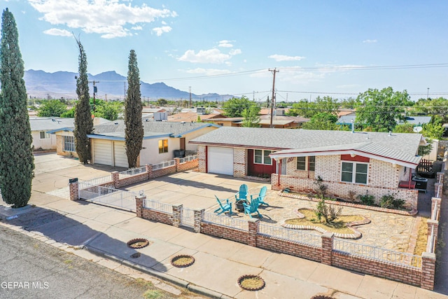 5137 Edmonton Ave, El Paso, TX 79924 - single story home with driveway, a mountain view, brick siding, and a gate