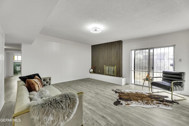 living room with a textured ceiling and wood finished floors