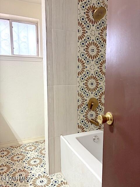 full bathroom featuring a bathtub, tile patterned flooring, and a shower