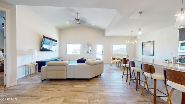 569 Logwood Ave, Canutillo, TX 79835 - living room featuring light wood-style flooring, healthy amount of natural light, a chandelier, vaulted ceiling, and ceiling fan