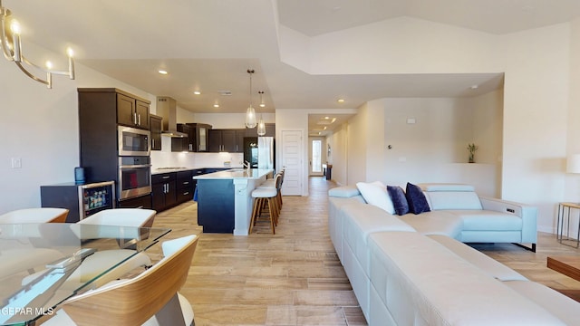 569 Logwood Ave, Canutillo, TX 79835 - living area with vaulted ceiling, recessed lighting, and light wood-style floors