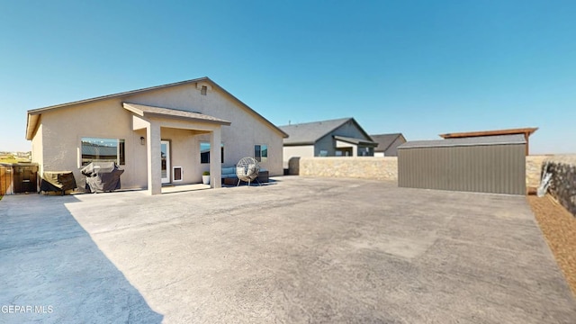 569 Logwood Ave, Canutillo, TX 79835 - rear view of house featuring stucco siding and a patio