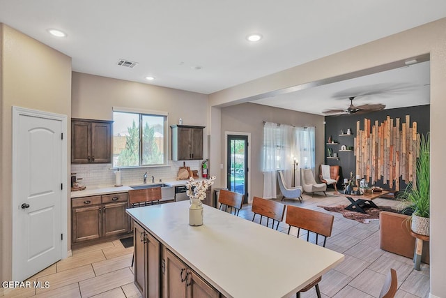 14809 Tierra Escape Ave, El Paso, TX 79938 - kitchen featuring open floor plan, light countertops, tasteful backsplash, a center island, and recessed lighting