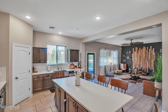 14809 Tierra Escape Ave, El Paso, TX 79938 - kitchen with open floor plan, decorative backsplash, light countertops, a sink, and recessed lighting