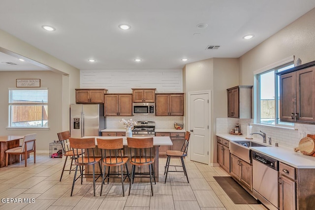 14809 Tierra Escape Ave, El Paso, TX 79938 - kitchen featuring stainless steel appliances, decorative backsplash, a kitchen breakfast bar, a sink, and recessed lighting