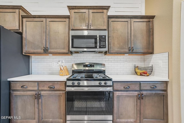 14809 Tierra Escape Ave, El Paso, TX 79938 - kitchen with stainless steel appliances, backsplash, and light countertops