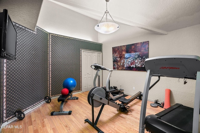 12081 E Paseo De Amor Ln E, El Paso, TX 79936 - workout area featuring a textured wall, wood finished floors, and a textured ceiling