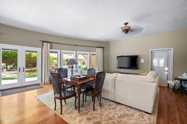12081 E Paseo De Amor Ln E, El Paso, TX 79936 - dining room with french doors, wood finished floors, and a textured ceiling