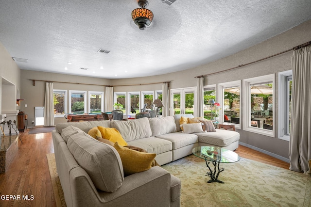 12081 E Paseo De Amor Ln E, El Paso, TX 79936 - living room with wood finished floors, healthy amount of natural light, a textured ceiling, billiards, and baseboards
