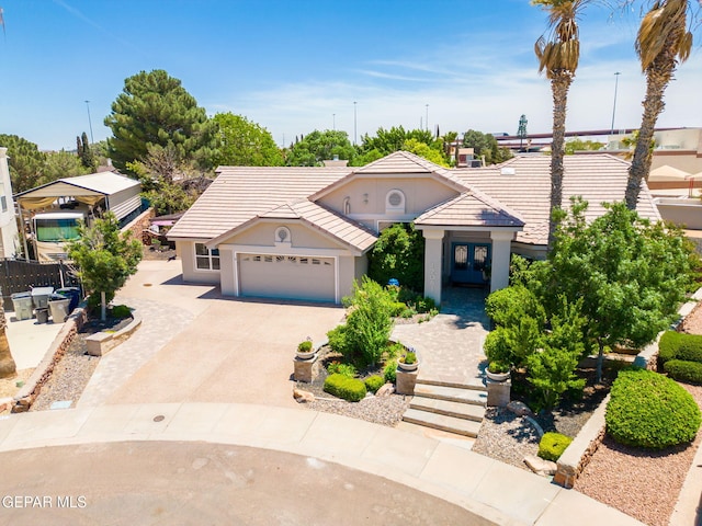 12081 E Paseo De Amor Ln E, El Paso, TX 79936 - view of front of home featuring a garage, a tiled roof, driveway, and stucco siding