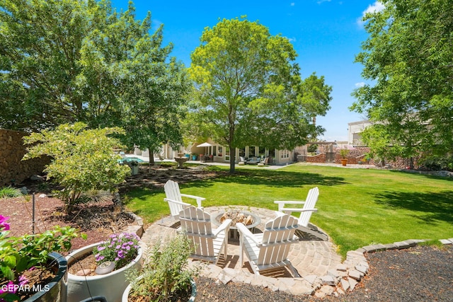 12081 E Paseo De Amor Ln E, El Paso, TX 79936 - view of green lawn with an outdoor fire pit