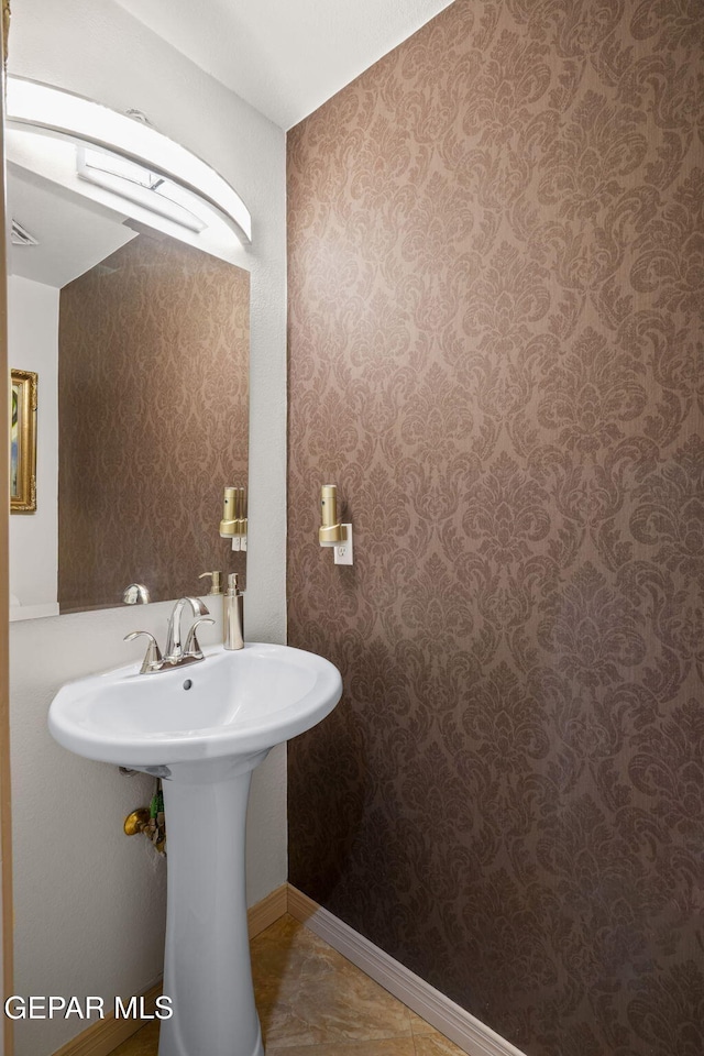 12081 E Paseo De Amor Ln E, El Paso, TX 79936 - bathroom with wallpapered walls and a sink