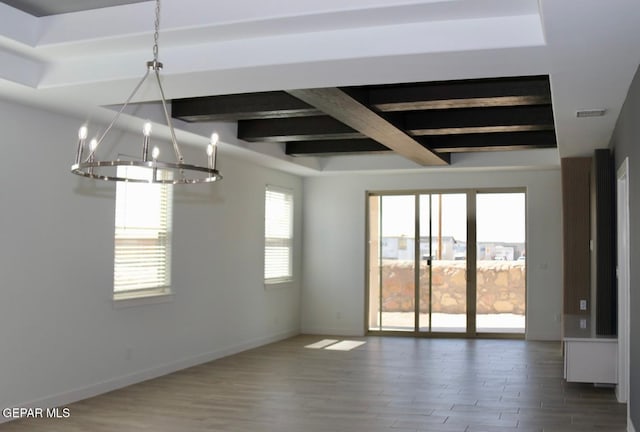 147 Bonnie Trl, Sunland Park, NM 88063 - unfurnished room with a chandelier, beam ceiling, and wood finished floors