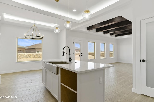 10700 Elise St, El Paso, TX 79924 - kitchen with a sink, baseboards, light countertops, open floor plan, and beam ceiling
