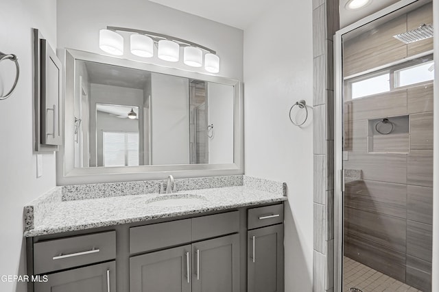 13804 Flora Vista Ave, Horizon City, TX 79928 - full bathroom with vanity, a stall shower, and ceiling fan