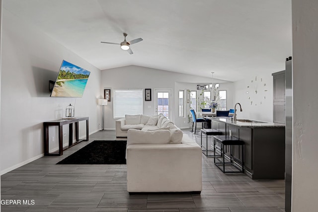 13804 Flora Vista Ave, Horizon City, TX 79928 - living room featuring lofted ceiling, a ceiling fan, baseboards, and a chandelier