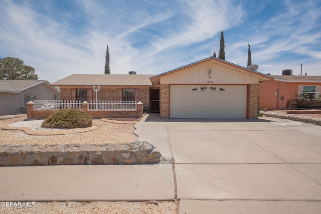 1662 Gene Torres Dr, El Paso, TX 79936 - ranch-style home featuring brick siding, a garage, and concrete driveway