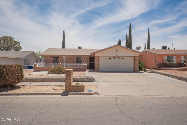 1662 Gene Torres Dr, El Paso, TX 79936 - view of front of home featuring an attached garage, driveway, brick siding, and a porch