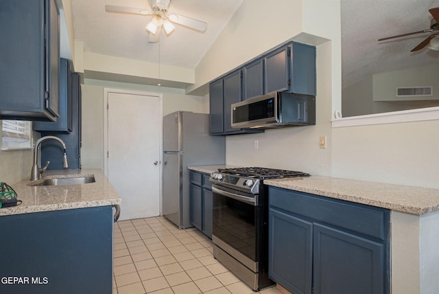 1662 Gene Torres Dr, El Paso, TX 79936 - kitchen featuring a ceiling fan, appliances with stainless steel finishes, a sink, lofted ceiling, and a textured ceiling