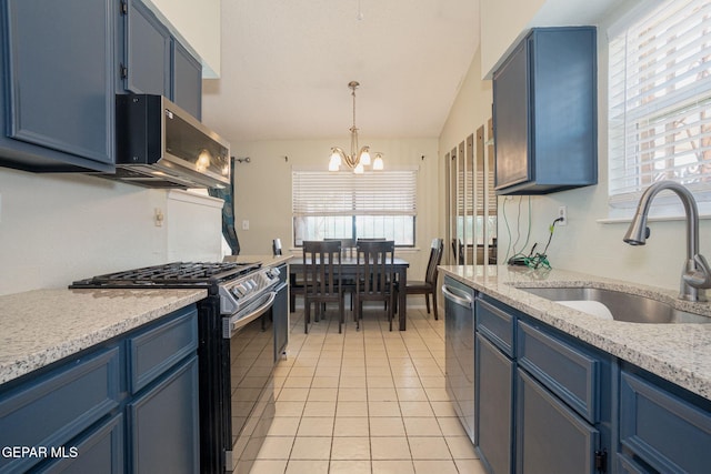 1662 Gene Torres Dr, El Paso, TX 79936 - kitchen with appliances with stainless steel finishes, a sink, blue cabinets, a chandelier, and light tile patterned flooring