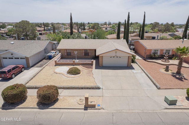 1662 Gene Torres Dr, El Paso, TX 79936 - single story home featuring brick siding, a residential view, driveway, and a garage