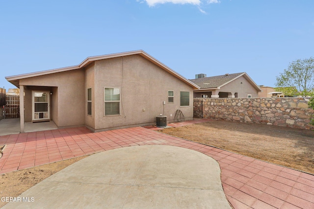 14239 Trigger Rock Ln, El Paso, TX 79938 - rear view of property featuring stucco siding, a fenced backyard, and a patio