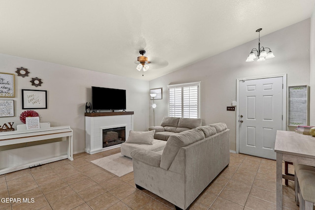 14239 Trigger Rock Ln, El Paso, TX 79938 - living area with lofted ceiling, light tile patterned floors, a glass covered fireplace, a chandelier, and ceiling fan