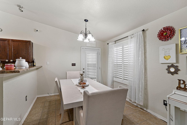 14239 Trigger Rock Ln, El Paso, TX 79938 - dining room featuring light tile patterned flooring, lofted ceiling, a chandelier, and baseboards