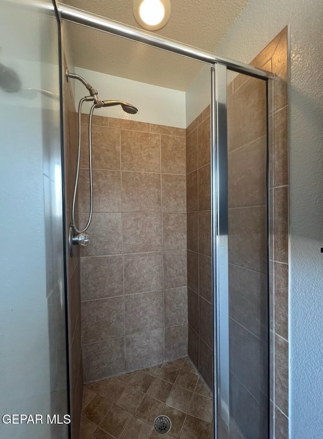 14239 Trigger Rock Ln, El Paso, TX 79938 - bathroom with a shower stall and a textured wall