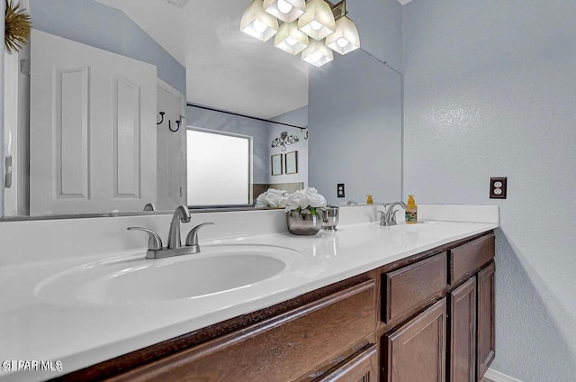14239 Trigger Rock Ln, El Paso, TX 79938 - full bathroom featuring double vanity and a textured wall