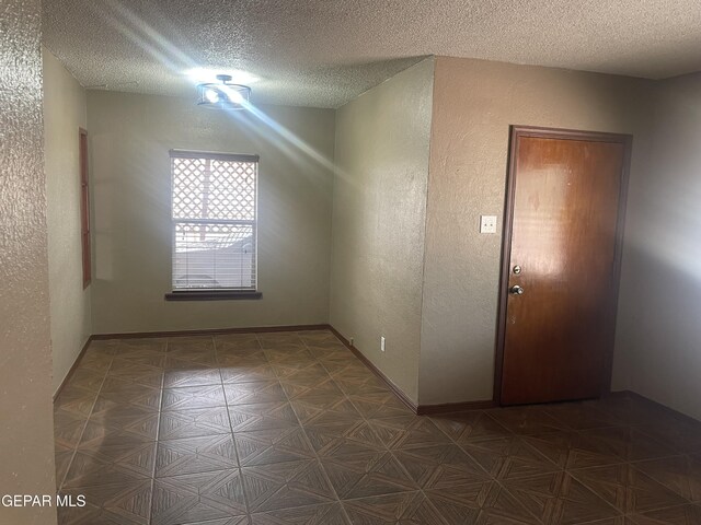 8324 Diana Dr, El Paso, TX 79904 - empty room featuring a textured ceiling and a textured wall
