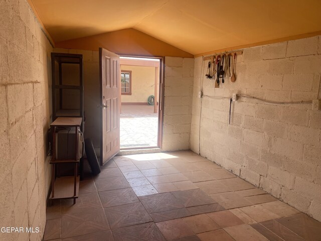 8324 Diana Dr, El Paso, TX 79904 - corridor with lofted ceiling and concrete block wall