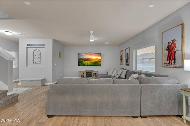 14953 Willie Worsley Ave, El Paso, TX 79938 - living room with stairs, light wood finished floors, and baseboards